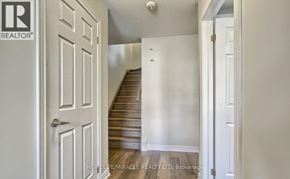 Cambridge townhouse for rent - A hallway with a wooden staircase leading to the second floor.