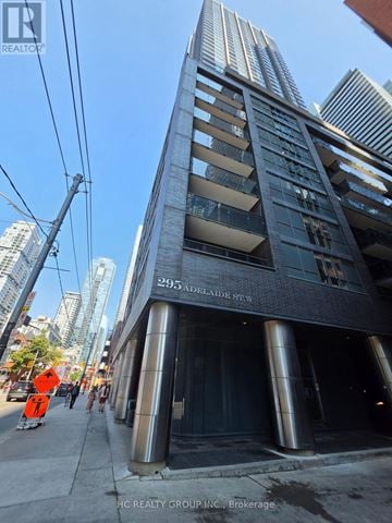 Toronto (Waterfront Communities) condo for rent - A tall building with a sign that reads "295 Adelaide St W" is shown in the image.