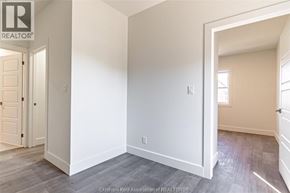 Chatham apartment for rent - A room with a door on the left and a window on the right.
