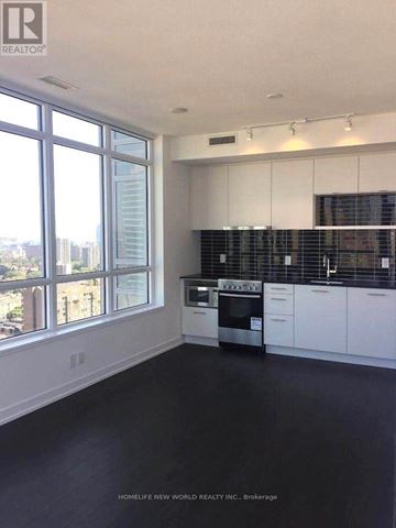 Toronto (Church-Yonge Corridor) condo for rent - A spacious kitchen with white cabinets and black countertops.