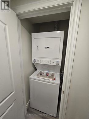 Richmond Hill (South Richvale) apartment for rent - A white dryer and washer are in a small closet.