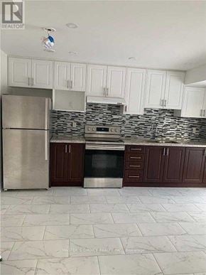 Markham (Victoria Square) townhouse for rent - A kitchen with white cabinets and a marble floor.