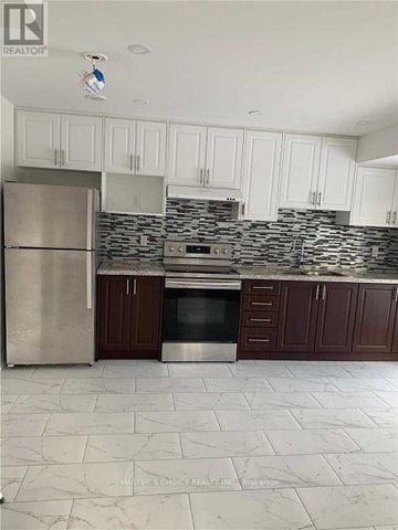 Markham (Victoria Square) townhouse for rent - A kitchen with white cabinets and a marble floor.