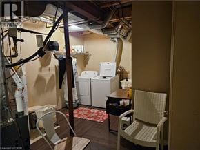 Ancaster apartment for rent - A room with a chair, a table, and a washing machine.