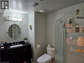 Ancaster apartment for rent - A bathroom with a toilet, sink, and mirror.