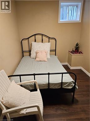 Ancaster apartment for rent - A bedroom with a bed, chair, and small table.