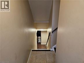 Ancaster apartment for rent - A hallway with a light on and a white vehicle in the background.