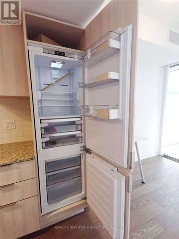 Toronto (Bay Street Corridor) condo for rent - A white refrigerator with its door open in a kitchen.