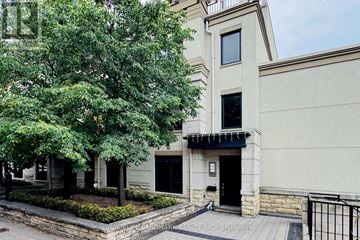 Toronto (Willowdale East) townhouse for rent - A building with a black gate in front.