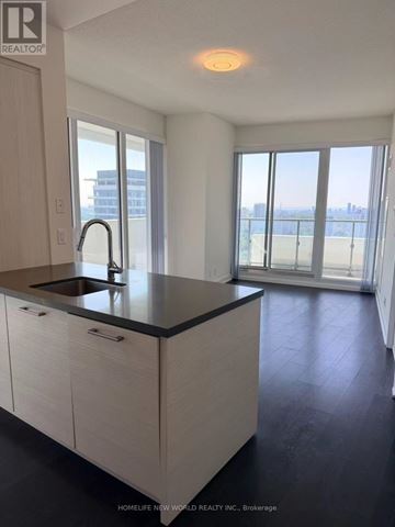 Toronto (Mount Pleasant West) condo for rent - A kitchen with a sink and a window overlooking a city.