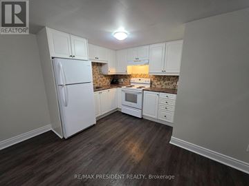 Burlington (Mountainside) apartment for rent - A kitchen with white cabinets and a white refrigerator.