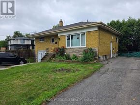 Burlington (Mountainside) apartment for rent - A house with a yellow front and a gravel driveway.