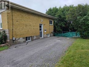 Burlington (Mountainside) apartment for rent - A brick building with a gravel driveway in front.