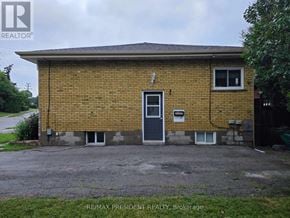 Burlington (Mountainside) apartment for rent - A small brick house with a gravel driveway in front.