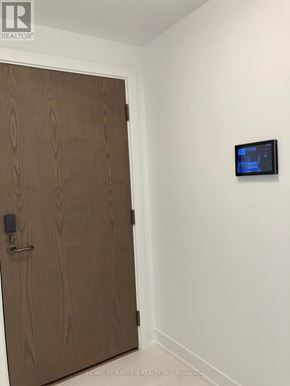 Toronto (Banbury-Don Mills) condo for rent - A brown door with a black lock and a small black screen on the wall.