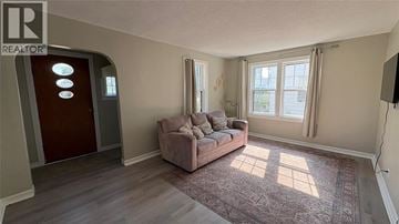 Sarnia apartment for rent - A living room with a couch and a rug.