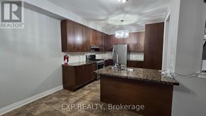 Oakville (Wt West Oak Trails) apartment for rent - A kitchen with brown cabinets and a granite countertop.