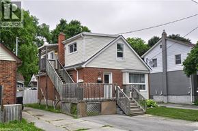 Cambridge apartment for rent - A house with a grey roof and a red brick chimney is surrounded by a wooden fence.