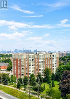 Toronto (Humber Heights) condo for rent - A tall residential building with a city skyline in the background.