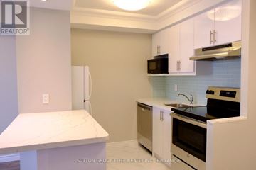 Toronto (Bay Street Corridor) condo for rent - A kitchen with white cabinets and a marble countertop.