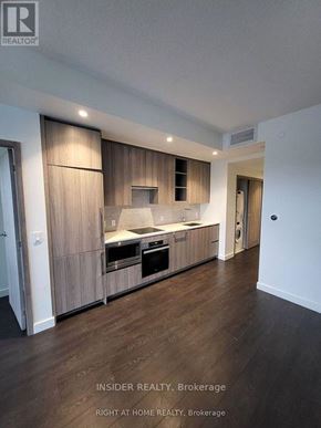Toronto (Bayview Village) condo for rent - A modern kitchen with wooden cabinets and appliances.