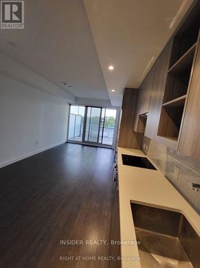 Toronto (Bayview Village) condo for rent - A modern kitchen with dark wood floors and a stainless steel sink.