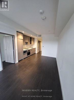 Toronto (Bayview Village) condo for rent - A spacious kitchen with wooden floors and white walls.