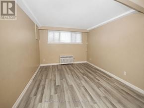 Toronto (Oakwood Village) multi-family for rent - A room with wooden flooring and a window with blinds.