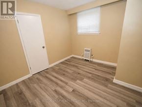 Toronto (Oakwood Village) multi-family for rent - A room with a white door and a window with blinds.