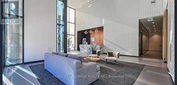 Toronto (Mount Pleasant West) condo for rent - A modern living room with a grey sofa and a coffee table.