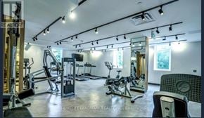 Toronto (Mount Pleasant West) condo for rent - A well-equipped gym with various exercise machines and a large mirror on the wall.