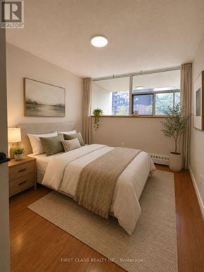 Mississauga (Sheridan) condo for rent - A bedroom with a large bed and a window with a view of the outside.