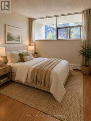 Mississauga (Sheridan) condo for rent - A bedroom with a large bed and a painting on the wall.