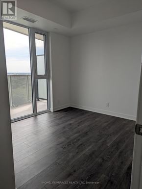 Vaughan (Steeles West Industrial) condo for rent - A room with a sliding glass door leading to a balcony.