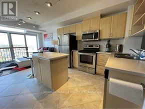 Mississauga (Mississauga Valleys) condo for rent - A kitchen with wooden cabinets and a large island.