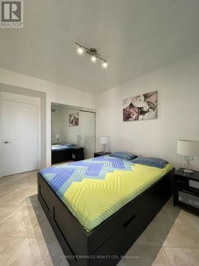 Mississauga (Mississauga Valleys) condo for rent - A bedroom with a bed, nightstands, and a painting on the wall.