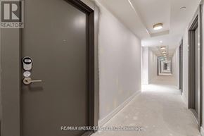 Toronto (Niagara) condo for rent - A hallway with a door on the left and a wall on the right.