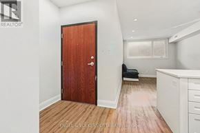 Ottawa multi-family for rent - A room with a wooden floor and a brown door.