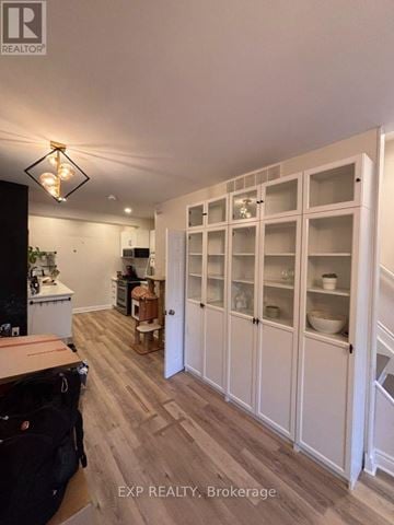 Ottawa townhouse for rent - A kitchen with white cabinets and a black fridge.