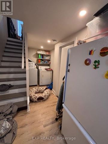 Ottawa townhouse for rent - A white refrigerator with magnets and a door open in a kitchen.