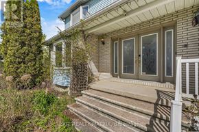 Russell apartment for rent - A house with a front porch and steps leading up to it.