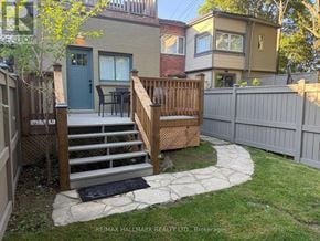 Toronto (Yonge-Eglinton) apartment for rent - A backyard with a wooden deck and stairs leading to a house.