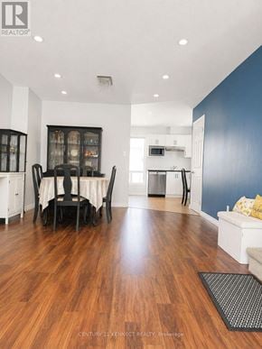 Oshawa (Vanier) apartment for rent - A dining room with a wooden floor and a white table with chairs.