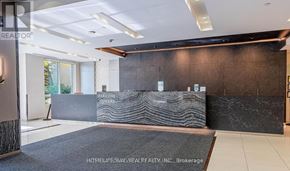 Markham (Grandview) condo for rent - A reception area with a dark marble wall and a grey carpet.