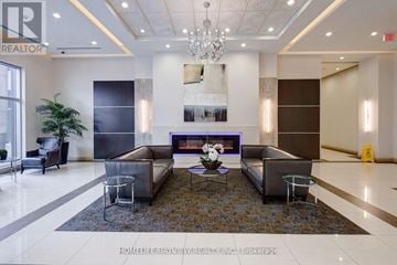 Markham (Grandview) condo for rent - A living room with a large couch and a coffee table in the center.