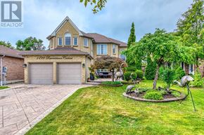Mississauga (East Credit) apartment for rent - A house with a well-maintained lawn and a sculpture in the front yard.