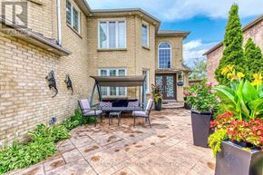 Mississauga (East Credit) apartment for rent - A patio with a table and chairs is surrounded by a brick wall and a variety of plants.