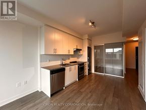 Hamilton (Beasley) condo for rent - A kitchen with white cabinets and a black countertop.