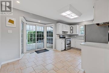 Hamilton (Huntington) apartment for rent - A kitchen with white cabinets and a tiled floor.