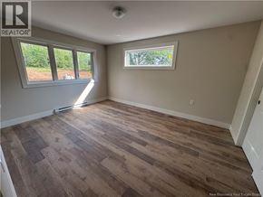 Hampton apartment for rent - A room with wooden flooring and a window overlooking a field.
